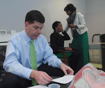 Mayor Walsh, Sen. Forry prepare for breakfast. : Forry is assisted by cousin Carolyn Brunis in the "green room" Photo by Don West